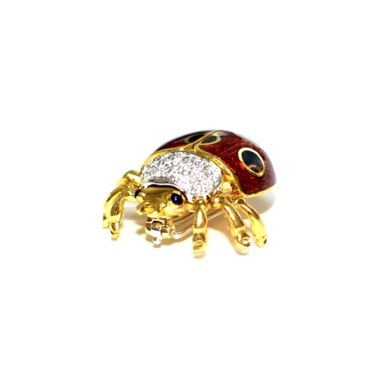 Style: Lady Bug Pin

Metal: 18k  Yellow Gold

Diamond: G-VS1

Diamond Weight: Approx .75

Enamel: Red And Black.

Eyes: Amthyest

Signed: Garavelli

Hallmarks: 18k Italy 750