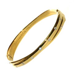 Tiffany & Co  Yellow Gold and Diamond Etoile Bangle Bracelet.