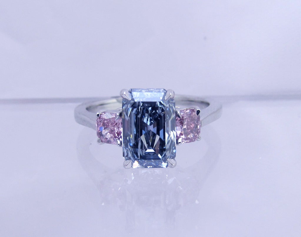 Magnificent!!   -ONE OF A KIND - Solitaire Ring!

Natural Intense Blue Rectangular Step Cut diamond flanked by pair of   Pink Color Rectangular Modified brilliant diamonds.
 
Center  diamond is:
Shape:    Rectangular Step Cut
Weight:  