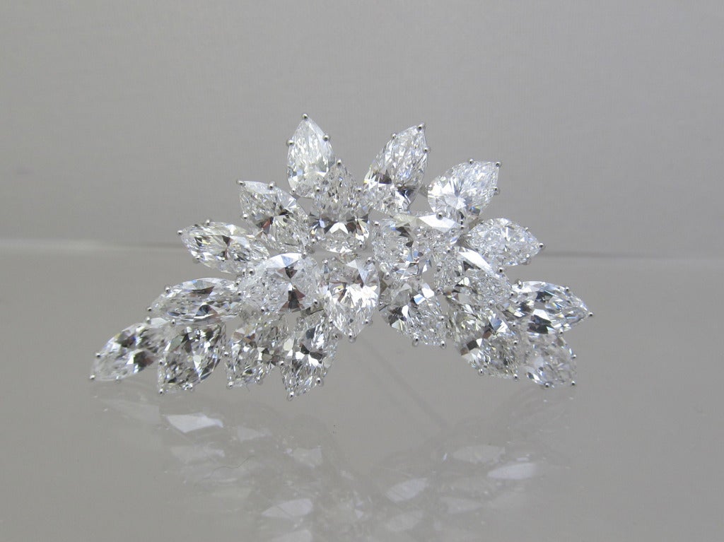 Gorgeous Harry Winston Brooch

11 marque & 9 pear shape diamonds set in platinum.
Estimated diamond weight is 20 carats (each diamond is 1carat)
Color: E/F
Clarity: VS1
Hallmark:   HW  # 32776