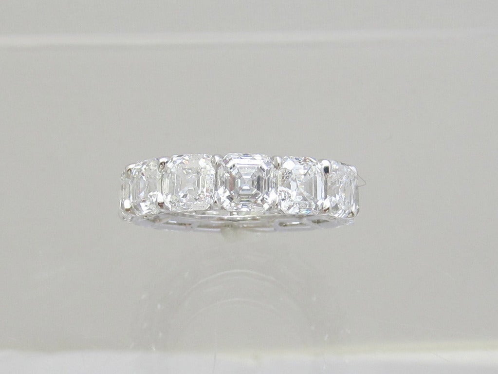 Stunning! all G.I.A. certified diamond eternity band
13 beautiful square shape diamonds set in platinum with shared prongs.
Total weight of the diamonds is: 13.49ct.  Here is itemized description.
G.I.A. certified.
 1.01ct      E-VVS2  
 1.01ct