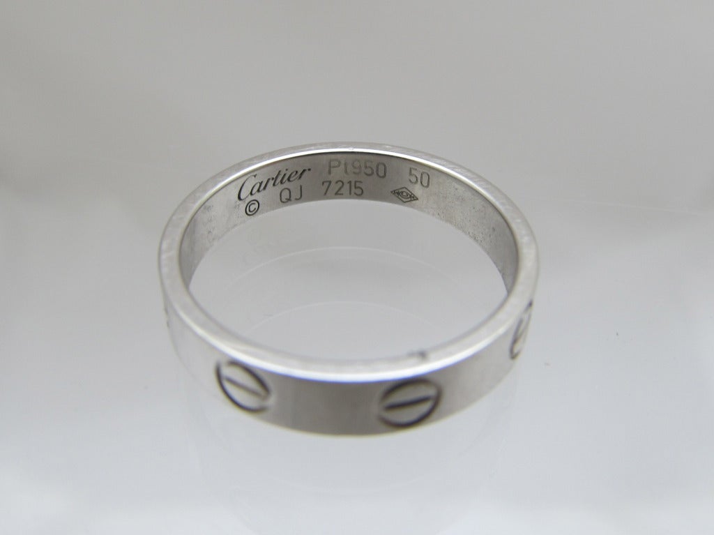 Love ring by Cartier.
Signed: Cartier 
950 50 QJ 7215 
 Weight: 2.6dwt.,
 Ring size 5.5,   European size 52
 Width: 3mm.
Platinum