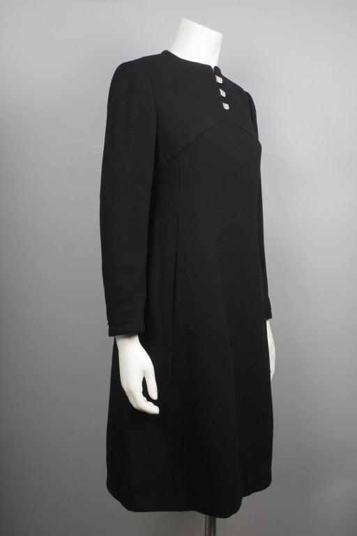 50% OFF! Originally $450

Black 3/4 sleeve shift dress with large rhinestone embellished clasps at the neckline and sleeves.