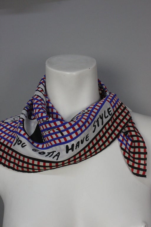 Silk scarf by Moschino with check pattern background and print of Popeye's Olive Oyl in several different looks.