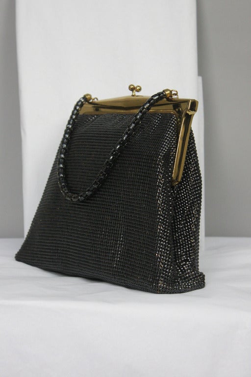 Black diamond shape mesh purse with goldtone frame top closure. Short diamond mesh handle. Original mirrors included. 5