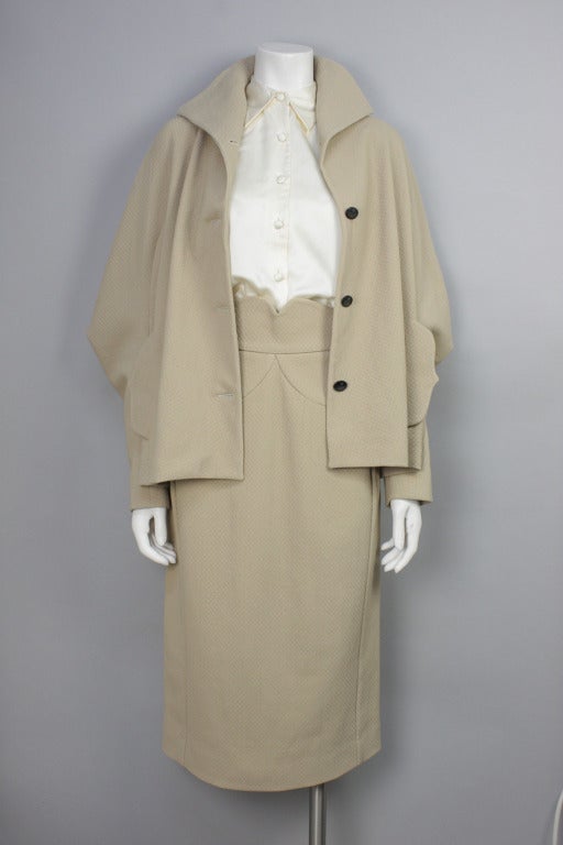 Now on sale! Original price $1500

Beige cotton and wool skirt suit by Vivienne Westwood Red Label. Gorgeous high waist skirt and voluminous jacket with distinctive shaped pockets.