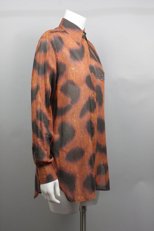 SALE! Originally $435
Sheer cotton leopard print blouse with long sleeves. Vivienne Westwood world logo on front and logo button at neck. Elongated silhouette, covers the hips.
