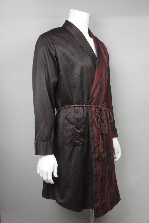Luxurious and unusual men's robe made with half panels of stripes and polka dots and an asymmetrical hem. Tassel rope belt.
