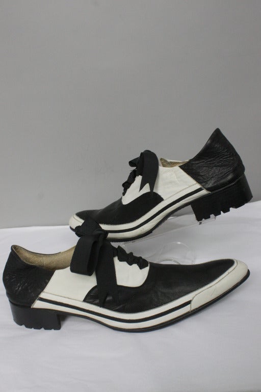 Men's black and white leather shoes with exaggerated pointed toes and ribbon laces. 1.5