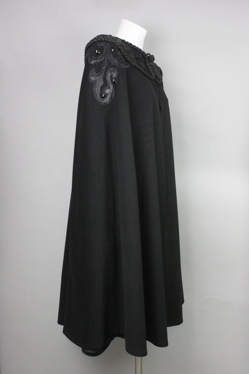 Beautiful black cape with jet-like faceted embellishments and small beads. It has braided trim and toggles. See last image for measurements.