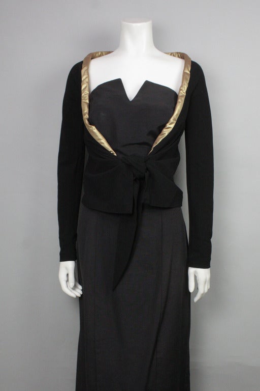 SALE! Original price $425

Black stretch wool crepe jacket with gold trim and tie front.