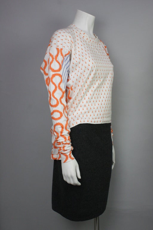 Iconic and rare shirt from Vivienne Westwood and Malcolm McLaren's World's End line. Features famous squiggle pattern in orange and blue. Asymmetrical hem-- cut short in the front and long in the back.

This same style was worn by Boy George, John