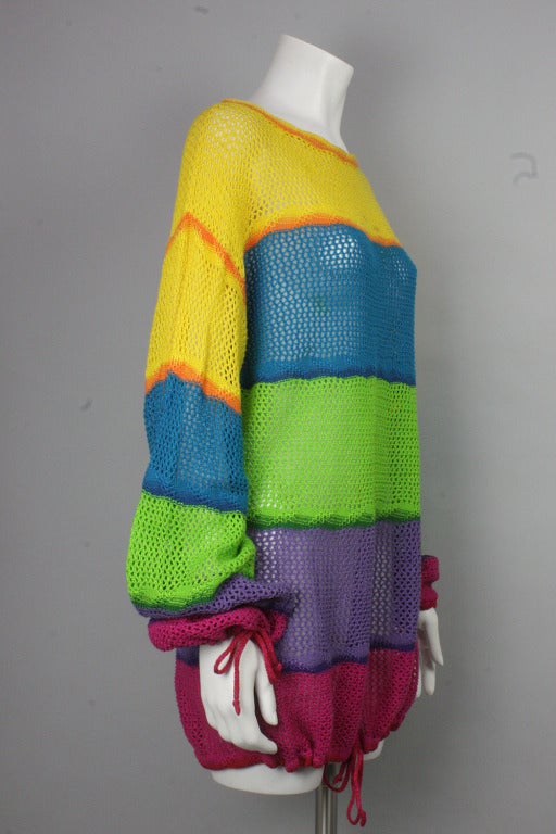Color block striped loose crocheted sweater with drawstrings at sleeves and bottom hem. 
