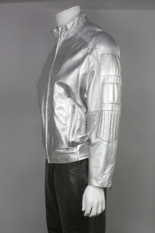 SALE Originally $1,795
Silver leather jacket cropped at the waist. Stitched detail down the sleeves and at the waist. Two outer pockets and one inner. Zip front, snaps at waist.