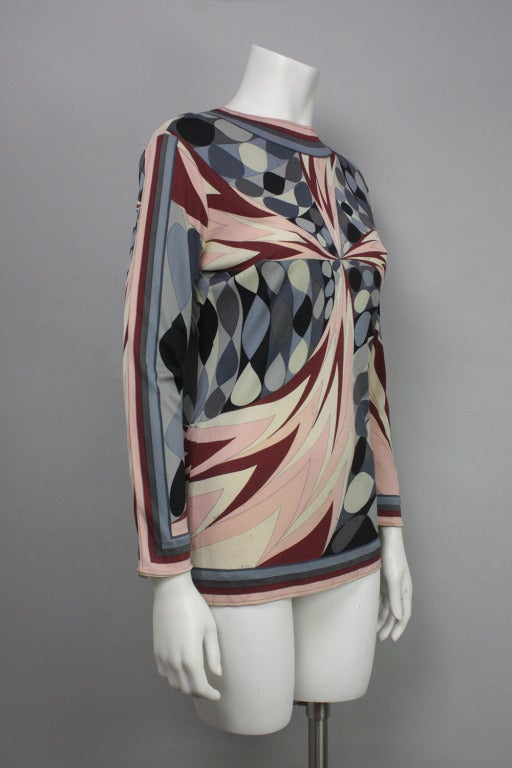 Long sleeve silk blouse in a classic Pucci geometric print and a maroon, pink, and gray colorway. Zippered back from collar to 3/4 down.