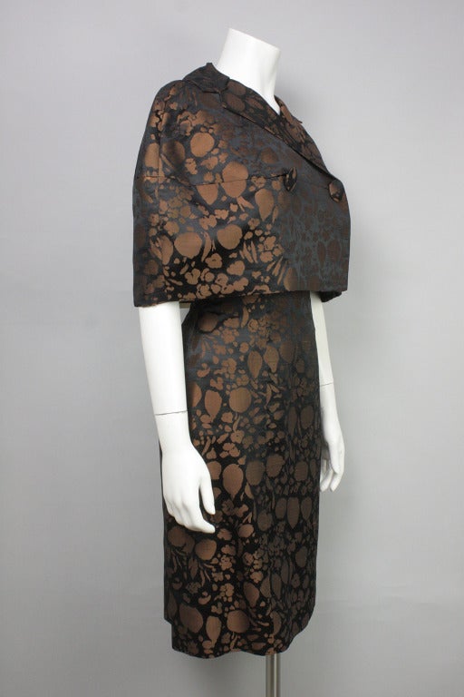 Brown and black brocade ensemble of strapless dress and capelet with two large buttons. Beautifully constructed.

Please see last images for measurements.