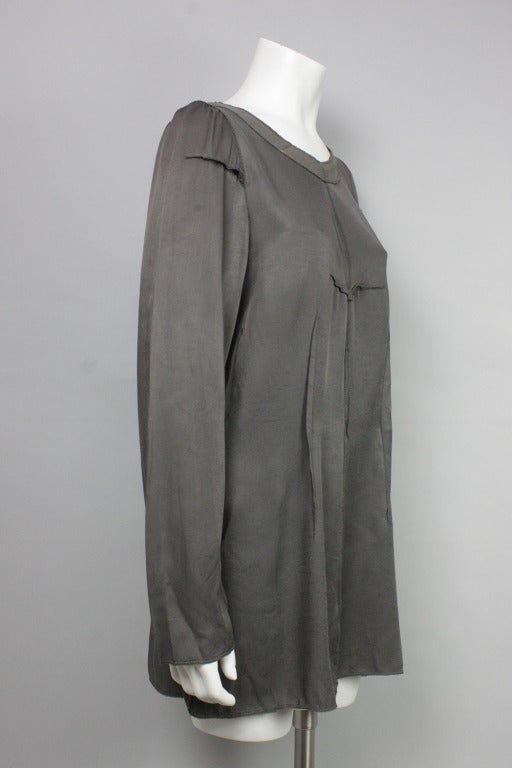 Gray long sleeved top with exposed seaming and decorative zipper at left side.  100% rayon.