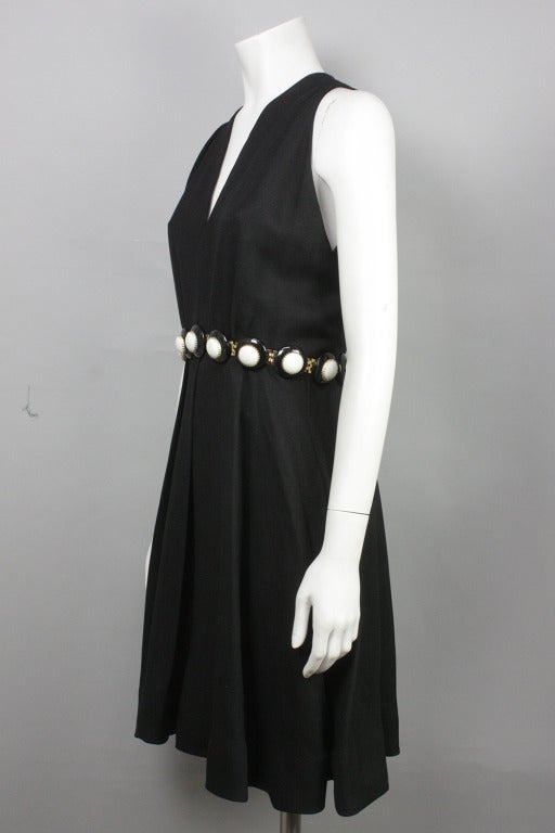 Gorgeous black wool crepe dress with a flared, pleated skirt and statement-making gold, white, and black belt attached.