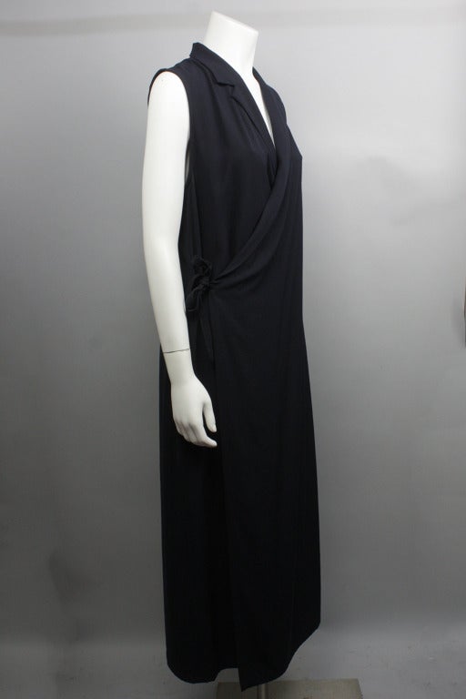 SALE!  Originally 625

Ankle length sleeveless wool dress can be worn alone or layered as a jumper. Features a deep notched collar and closes with a tie at the waist.