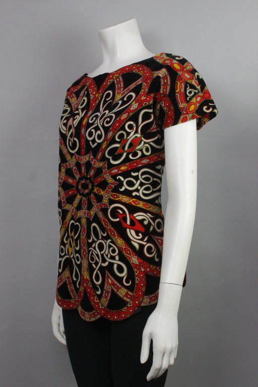 Pucci cotton velvet top with a classically Pucci floral-esque print bursting from the center. The hem is scalloped to match the print.