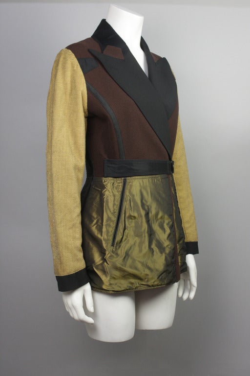 SALE! Originally $975
A mid 1980s showroom sample, this JPG jacket is a clever mix of fabrics: metallic sleeves, ribbon trim, and a satin bottom adorn a wool body. Two front slash pockets and an attached belt complete the design. Two small pockets