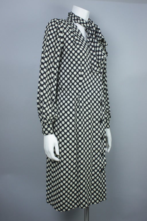 20% OFF! Originally $450

Long sleeve silk wrap dress with button and snap closure. Pleating and slight padding at shoulders. Decorative front tie.