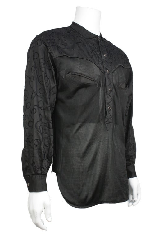 Over 50% OFF! Originally $525

Black mesh semi-sheer men's shirt with yoke with decorative accents on sleeves, yoke, and center. Red circular buttons, two distinctive breast pockets.