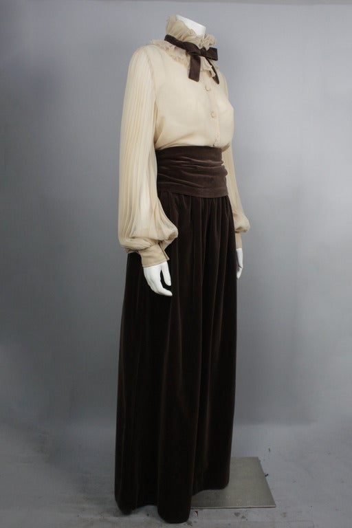 15% OFF! Originally $350

Gorgeous Lille Rubin three piece set. Sheer beige blouse with full,  pleated sleeves and high neck collar with brown velvet bow. Snap and hook and eye at neck to close. Brown velvet maxi skirt with pockets and cummerbund