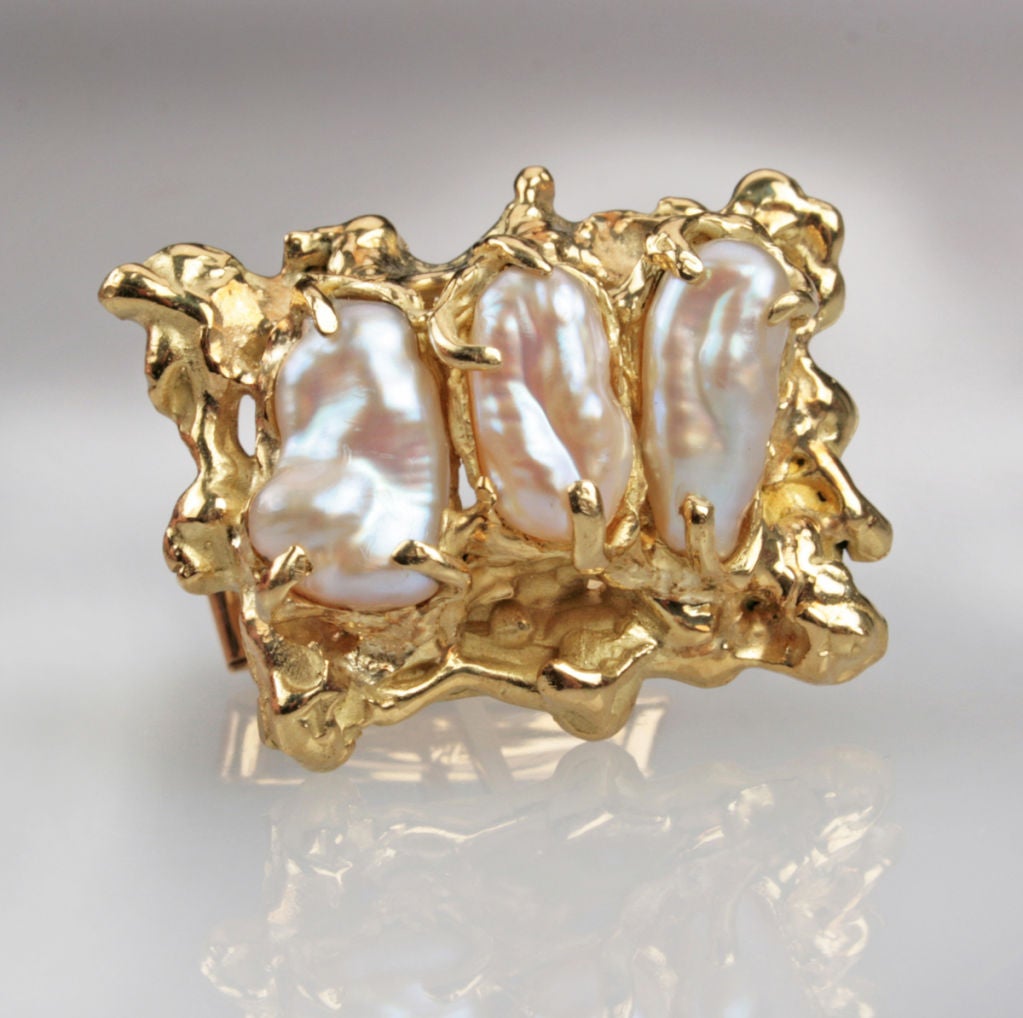 These great looking sculptural cufflinks feature three natural pearls set in a sculptural setting.  They were made by Barbara Anton.