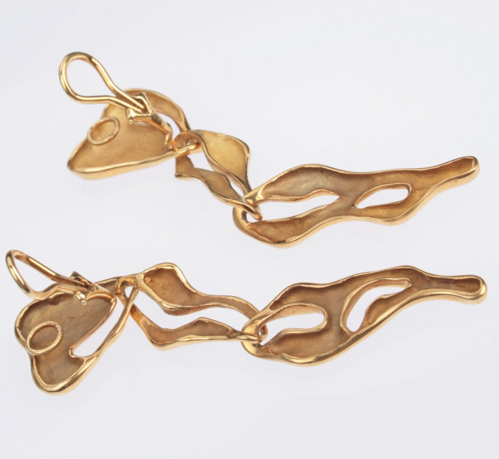 These sculptural earrings are nicely made and look great on.  They are marked on the back with a copyrigt and 750.