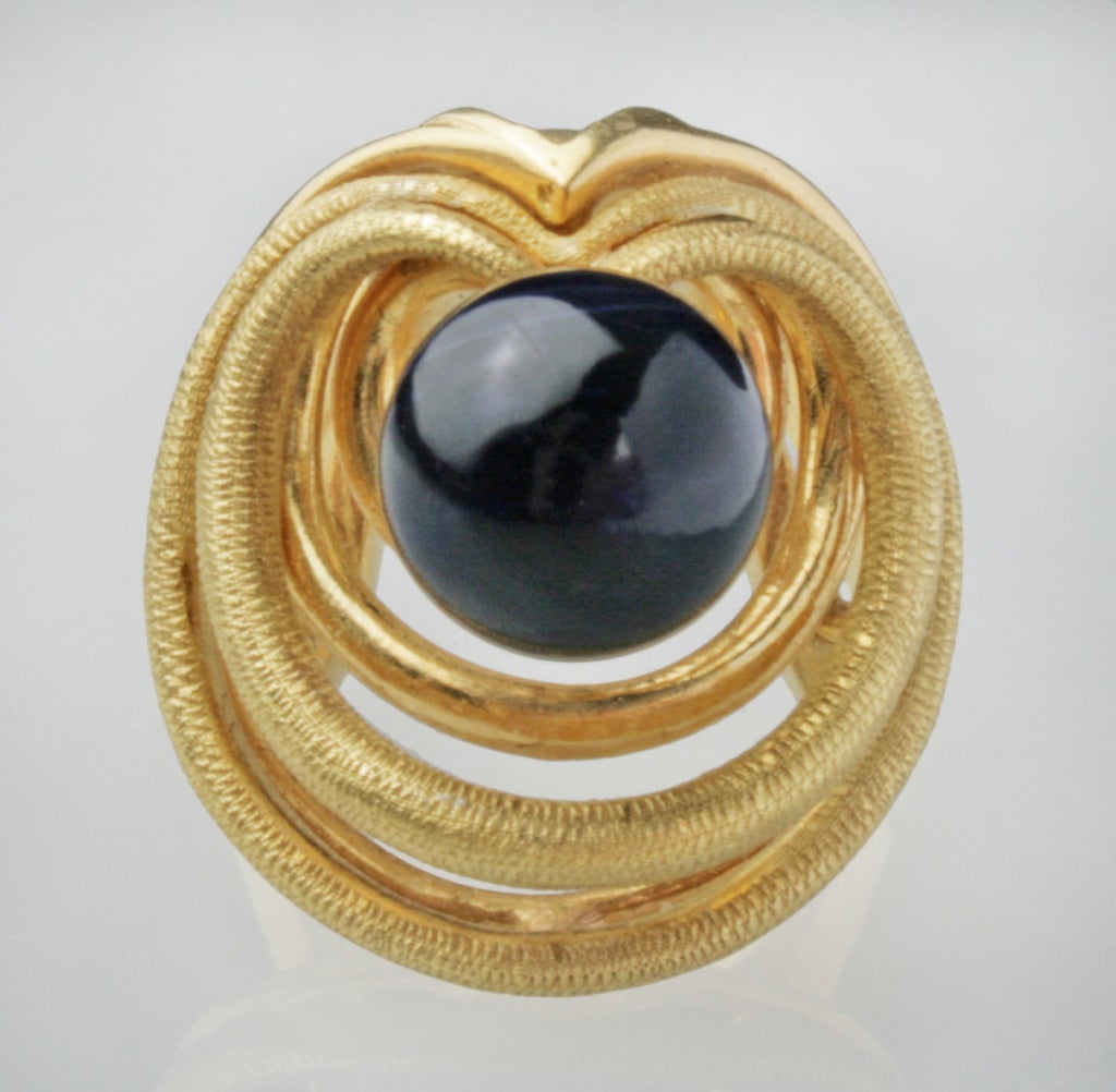 This is a very contemporary and fun 18kt gold ring set with a sodalite cabochon (.4 