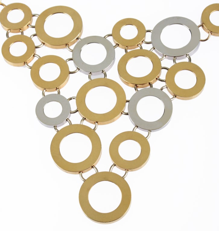 Comprised of linked disks of white and yellow gold, this is an unusual and beautiful necklace. It is stamped Italy and 18 K.