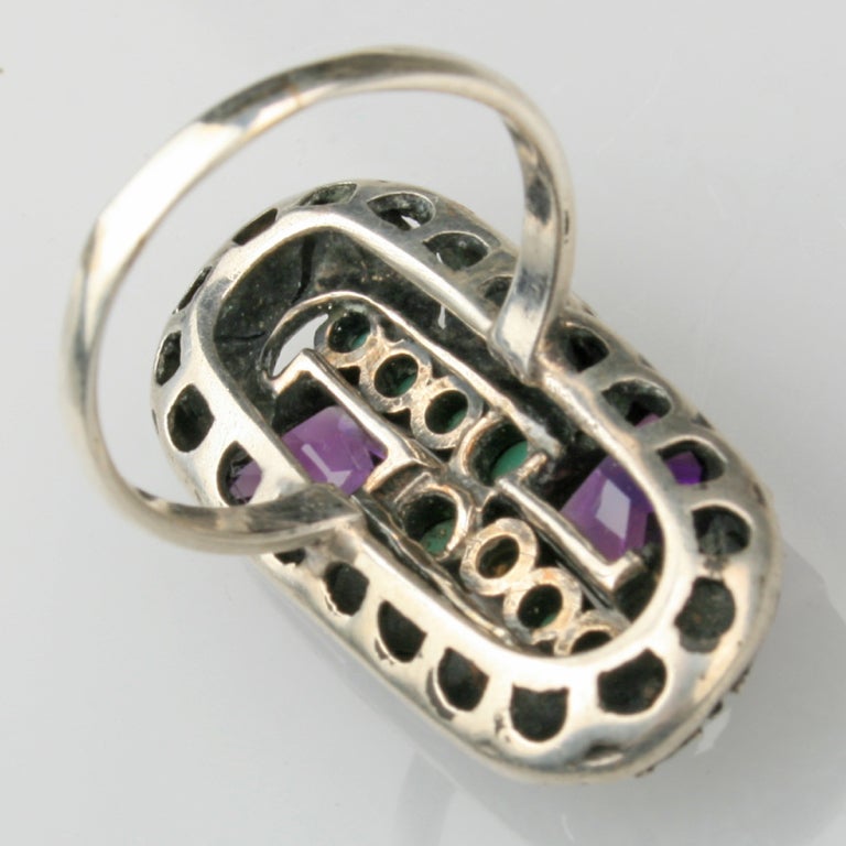 An Art Deco ring with turquoise, amethyst and marcasite. Sized 6.25-6.5. Shown with two other rings by Theodore Fahrner.