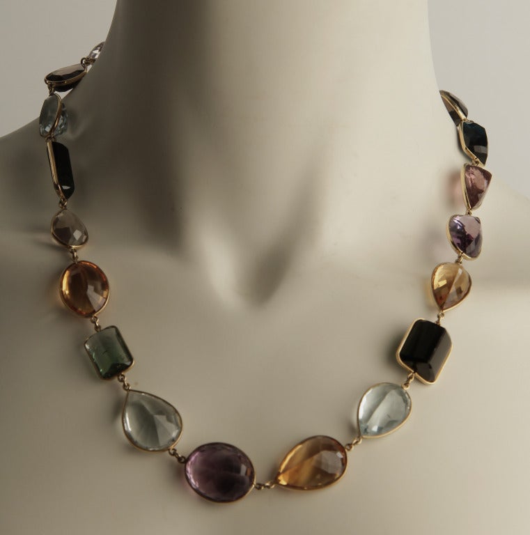 This beautiful necklace is comprised of faceted large stones; tourmaline, kunzite, smokey topaz, amethsyst, aquamarine, citrine and morganite to name a few.  It looks great by itself or with the longer necklace of semi precious stones we have.
