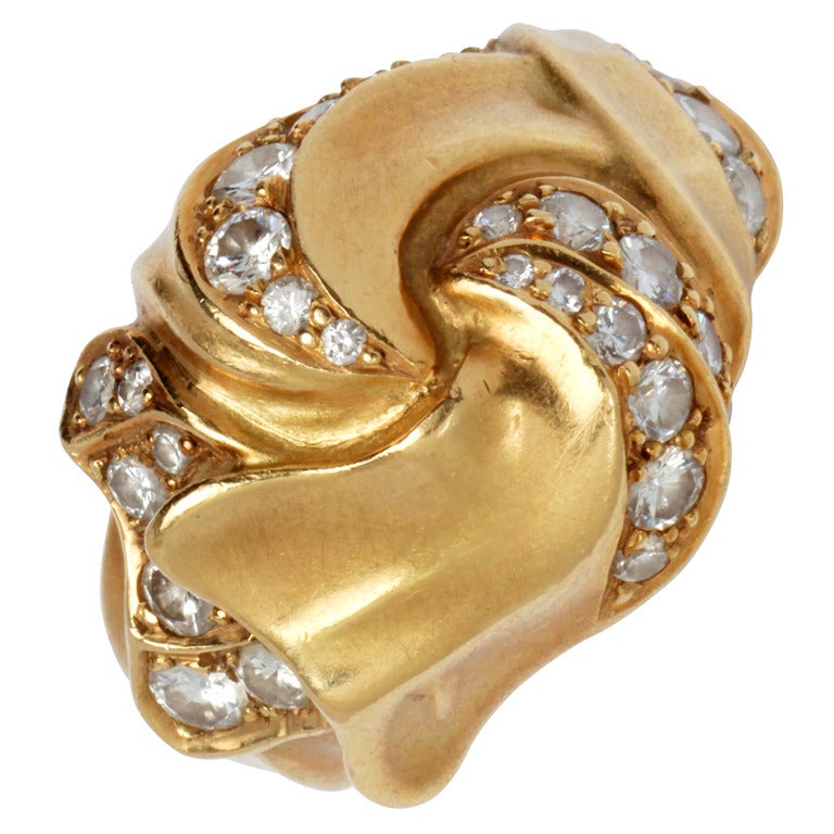 This is a lovely ring in a brushed satin finish with undulating curves encrusted with diamonds.