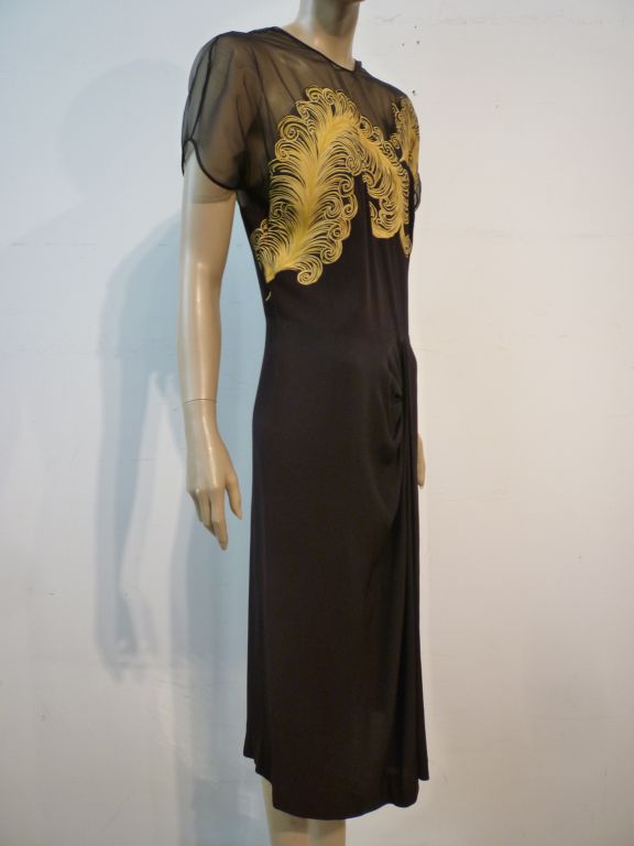 A wonderful 1940s Dorothy O'Hara original black crepe cocktail dress with quintessential 40s front hip drape and sheer organza shoulders and back with incredible dramatic chartreuse ostrich feather applique over the bodice and trailing to the back. 