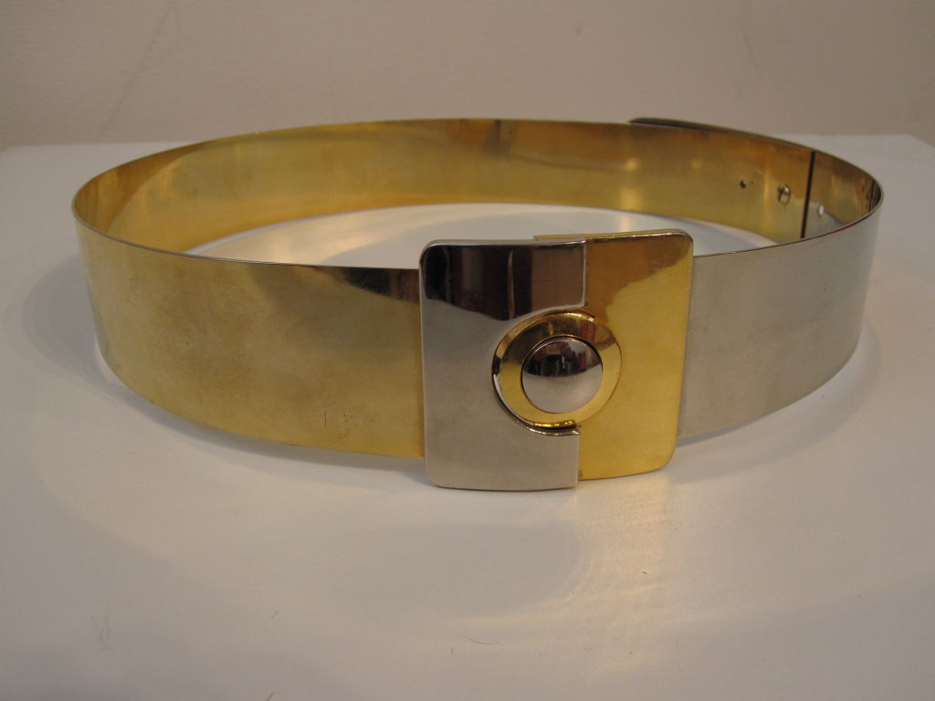 A great wide Modernist metal belt a la Pierre Cardin or Paco Rabanne in brass and stainless steel.  Center buckle is a push-button clasp and works  <br />
<br />
buckle is 2.5