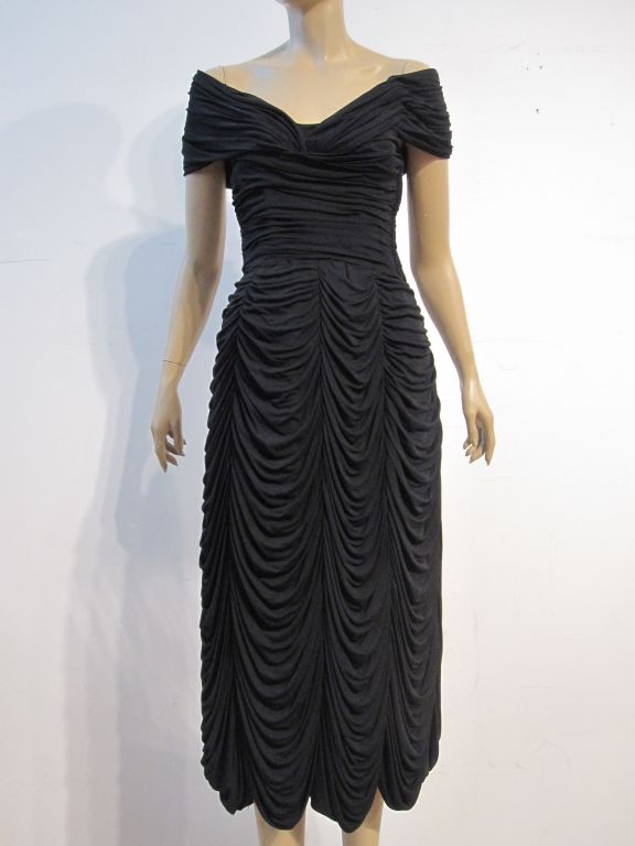 A wonderful Ceil Chapman 1950s black dress fashioned from intricately draped and gathered silk jersey with dropped shoulders and longer hem line.  Fantastic!