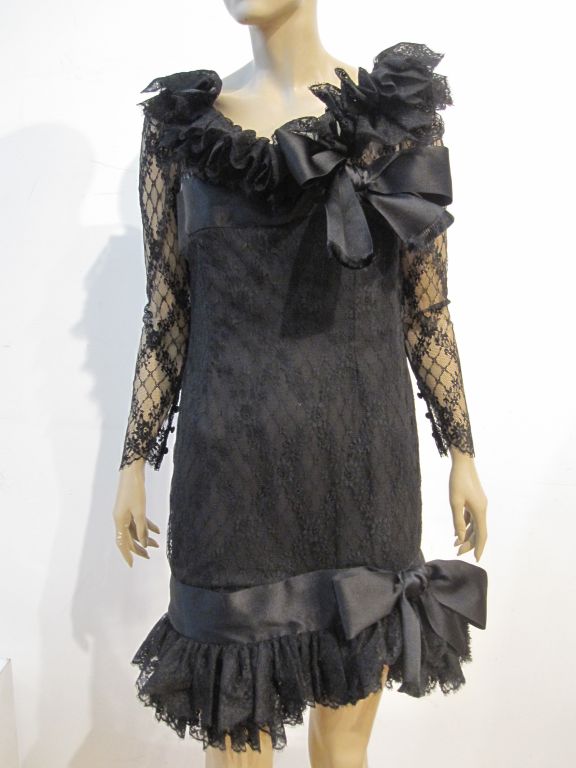 A fantastic Bill Blass 80s cocktail dress in black lace with ruffled lace and tulle neckline and hem, adorned with satin bows!  Gorgeous style!
