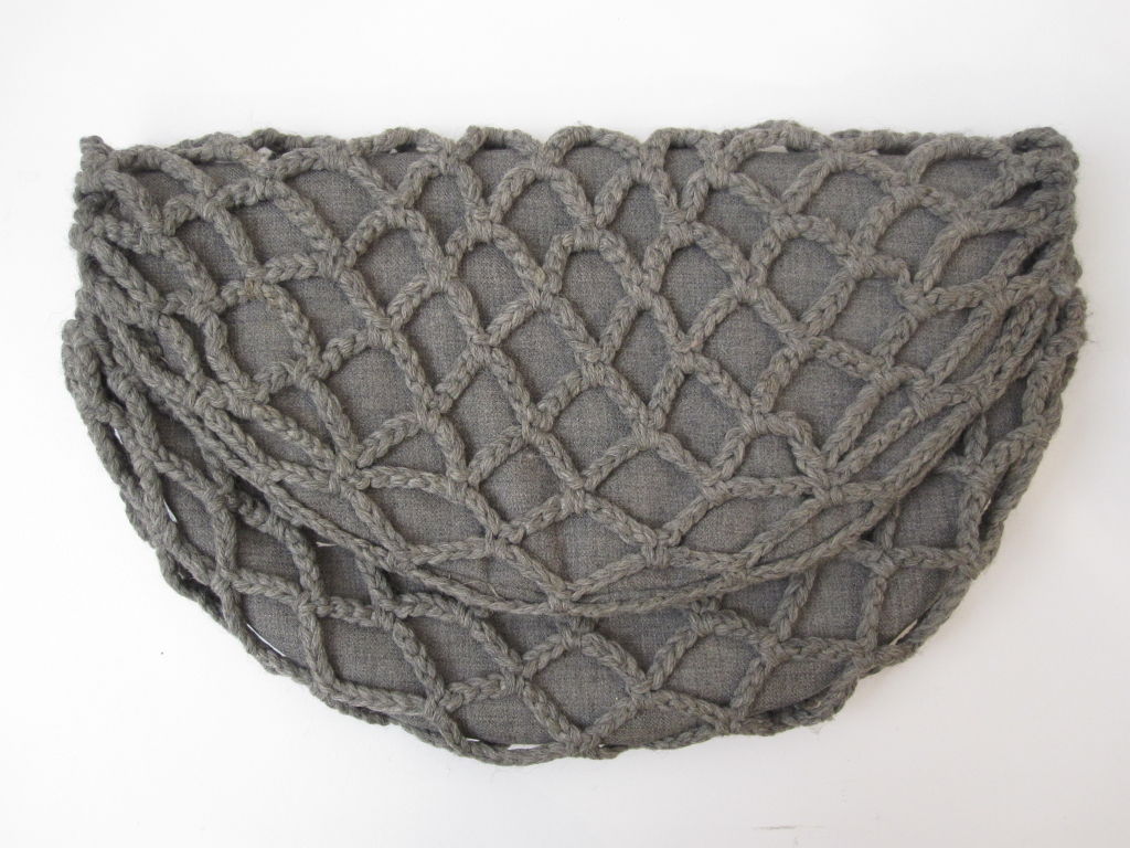 A very unusual design!  1940s gray flannel folded circular clutch with crochet net overlay.  Interior has flap and zippered pockets.  Some lining issues, but a fabulous, unusual design.