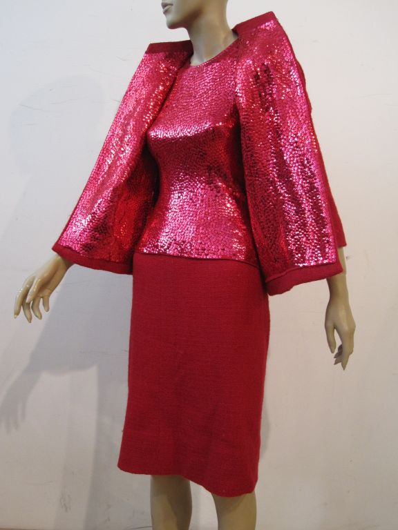 An iconic Norman Norell suit that epitomizes his style.  A classic red tweed early 60s boxy style suit jacket and skirt with an incredible solid sequined jersey blouse which is fitted and weighted around the hem. Add to that a matching jacket lining