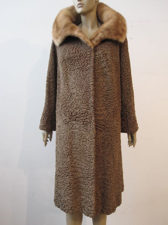 Beautiful 1950s taupe Persian lamb coat with tan mink portrait collar.  Quite possibly a Schiaparelli. Size 8-10.  Satin lined.  In excellent condition.