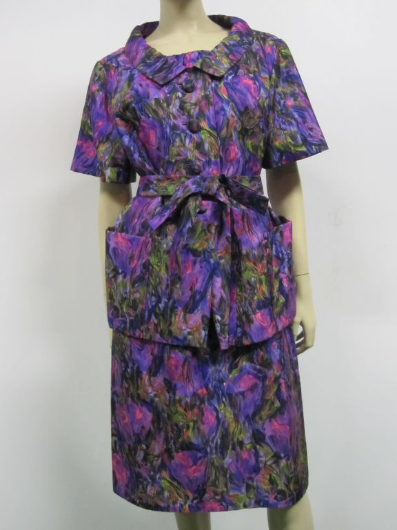 A beautiful early 60s Christian Dior-New York sheath dress and jacket in purple, fuchsia, black and green floral water-color print.  Originally sold at Nan Duskin. Size 8, in EXCELLENT condition