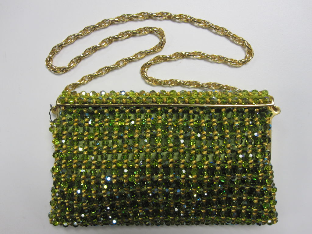 1950s hand-beaded bag made in France for Spritzer and Fuhrmann Ltd.  of peridot-tone green and aurora borealis and gold metal beading and lined in lime silk satin.  Gold-tone chain AND original matching beaded handle included.  Measures 8