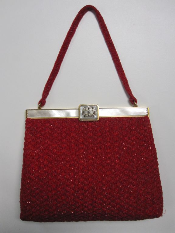 A beautiful hand-beaded evening bag made in France for David's Fifth Avenue.  The crimson beading is done in an unusual and beautiful 