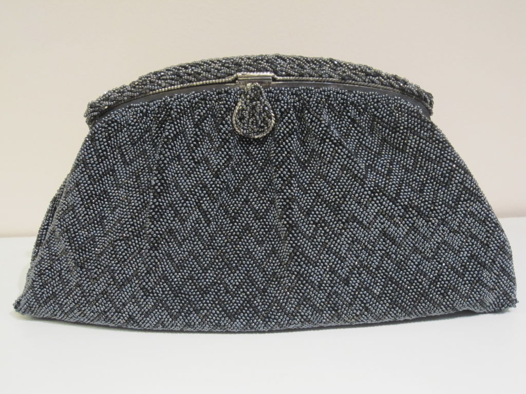 A fantastic 1940s French hand-beaded clutch in a gunmetal colored chevron pattern.  Slate satin lining is in excellent condition.<br />
<br />
Measures 10