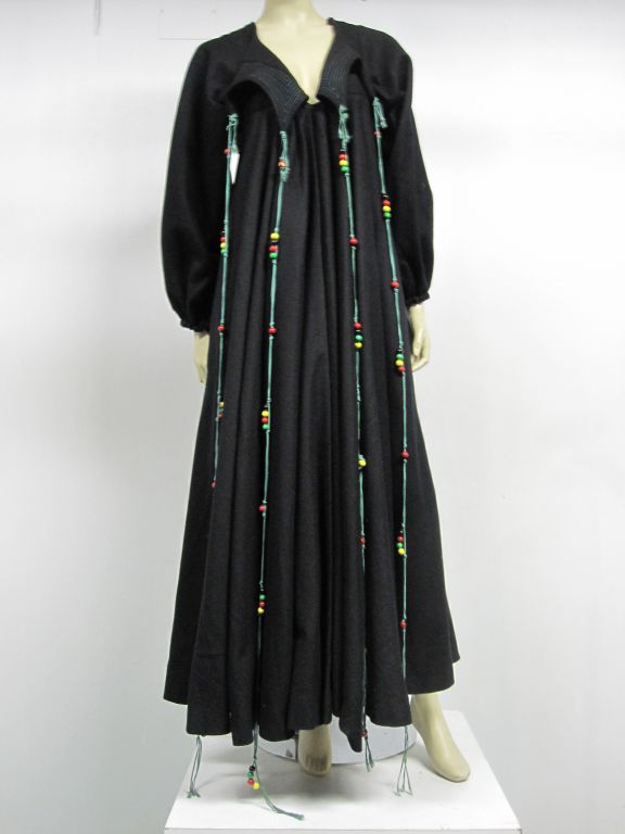 A wonderful Zandra Rhodes wool felt smock coat with unusual collar treatment, trapunto stitched with long beaded lacing.  Fitted in the shoulders and bust, this coat flares extravagantly to an extremely full circle hem.