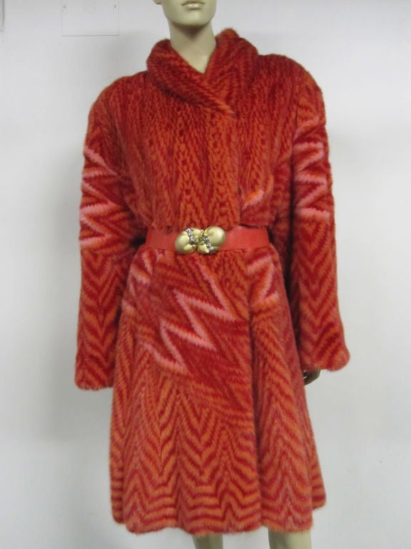 A rare and unique Zandra Rhodes graphic mink coat that she designed for Phillip Hockley Ltd. in the 80s.  Intricately pieced mink in red, orange and pink.  Pictured with a Judith Lieber 