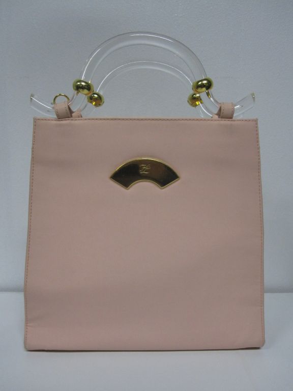 A great vintage Karl Lagerfeld pink neoprene handbag with detachable shoulder strap and super lucite handles.  Metal fan logo.  Measures 10