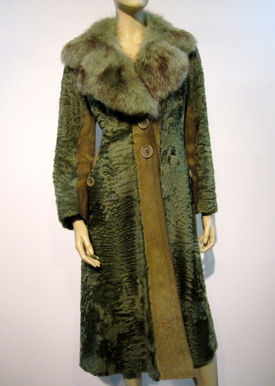 A wonderful 1970s trench style coat of dyed olive green broadtail lamb and suede sectioned piecing and matching dyed olive green fox collar!